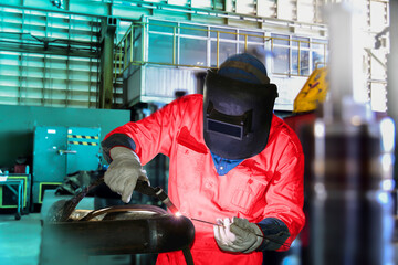 Welder industrial in factory welding process TIG with gas argon, light spark from working light...