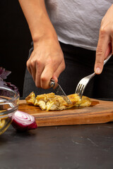 Cooking process, woman cut baked eggplant