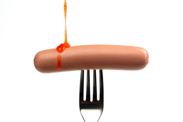Sausage on fork on white background