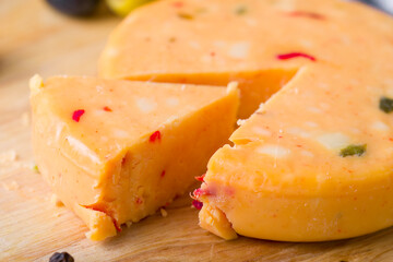 yellow cheese on a snack cracker

