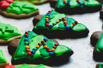 Close-up of a beautifully decorated gingerbread Christmas cookie made to look like a lit-up Christmas tree