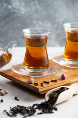 Two glass cups of tea with loose teas
