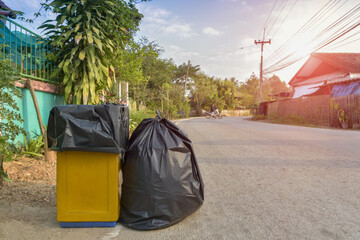 Pile black garbage bag roadside in the village