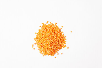 Red lentil groats. On a white background, horizontal orientation.