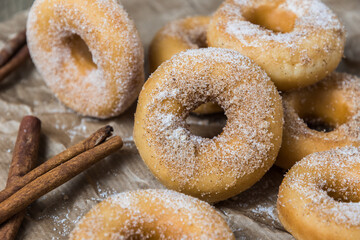 Closeup of mini donuts with sugar and cinnamon on a brown paper