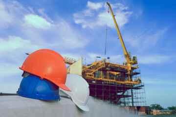 Blue, Orange and white Safety helmet stacked Oil Refinery factory construction structure platfrom of rig, The concept of safety cooperation in refineries.