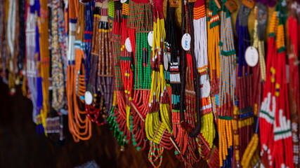 Selective focus with shallow depth of field image of colorful beads and various designs hanging
