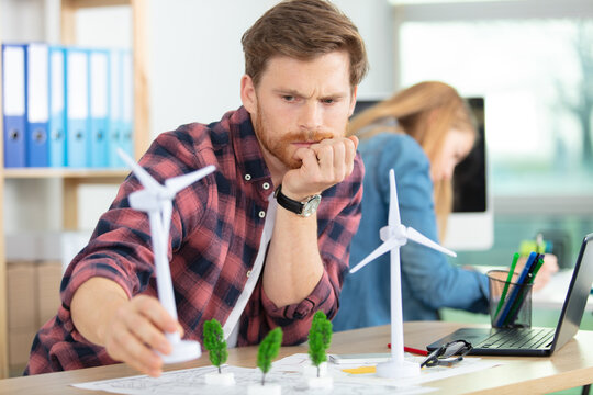 male architect studying plans in office
