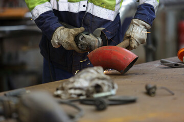 man cutting pipe by sawing machine