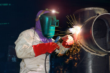 Industrial welding worker business concept with technician focus on welding process with equipment...