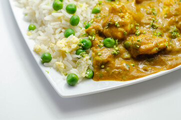 Chicken curry with egg fried rice, chicken breast pieces in a mildly spiced coconut curry sauce with fried rice with peas and egg