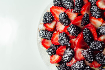 Butter enriched shortcrust pastry topped strawberries and blackberries, seasonal cake with colorful decoration