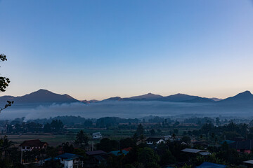View of mountains and green fields at Pua District, Nan, a small province in northern Thailand.