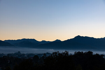 View of mountains and green fields at Pua District, Nan, a small province in northern Thailand.