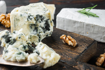 Blue cheese Gorgonzola, on dark wooden background