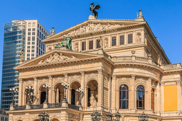 Fototapeta na wymiar Historic building of the old opera house in Frankfurt in springtime with sunshine. Public square in the center of the city with commercial and office buildings in the background