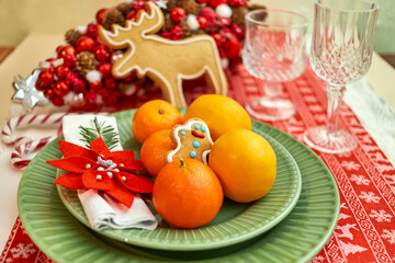 Christmas cookies with festive decor, Christmas tree, tangerines, beautiful dishes, glasses. Winter Holidays.