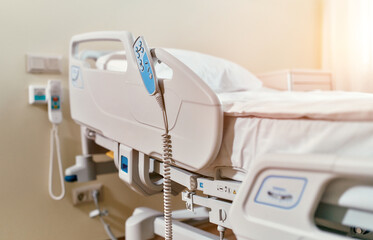 A modern hospital bed waiting to be occupied by a patient. Modern hospital beds are equipped with features from emergencies utilities to entertainment