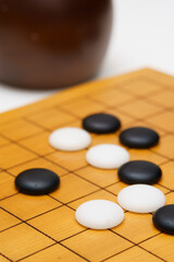 black and white baduk stones on wood board