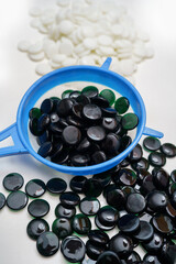 washing baduk stones - wet baduk or weiqi stones after cleaning on white