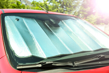 Sun shade under windshield in car, closeup. Heat protection