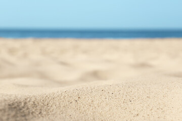 Fototapeta na wymiar Beautiful sandy beach and sea on sunny day, closeup. Summer vacation