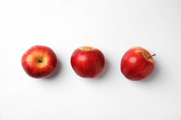 Fresh ripe red apples on white background, flat lay
