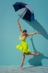 Dancer jumping with an umbrella