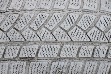 gray white plastic texture from an old dirty car tire with cracks