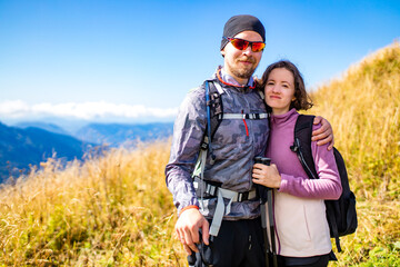 newwed couple hikers trekking in mountains in wedding honey moon