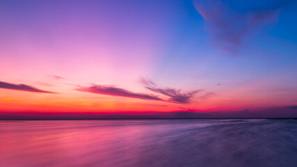 Fototapeta na wymiar sunset over the sea torn clouds the sun has already gone over the horizon