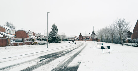 Winter landscape with snow covering the road inl village, Snow on street road in small town with bright light morming.