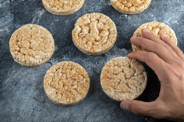 Male hands holding crispbread on marble background