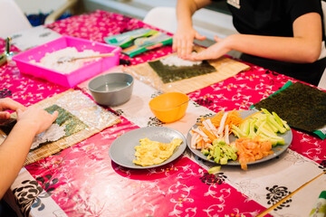 Concept cooking at home. People cooking sushi at home.