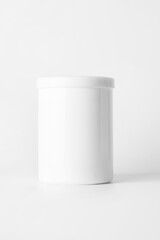 White container with a lid on a light background..