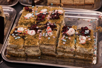 Festive New Year's cake decorated with decorative snowmen. Dessert on the counter of the store cafeteria.