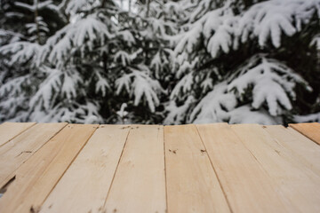 Empty table in the foreground with wooden boards
Nice cold day and blurred background.
Wintry with forest