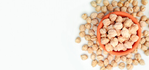 Uncooked dried chickpeas on white background with copy space