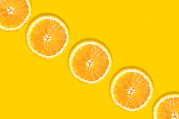 Fototapeta na wymiar Orange round slices on an orange background diagonally with space for text. Template, layout of your advertisement.