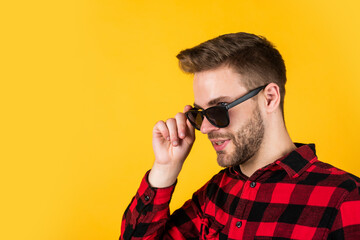 In traditional style. happy guy smiling. portrait of fashionable handsome man in shirt. business classic mens shirts with checkered print. confident man standing in shirt and glasses. copy space