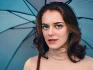 Beautiful young woman under an umbrella