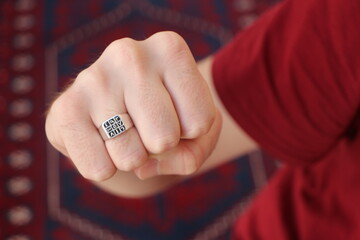 Man hand with a silver ring on his finger. Ottoman arabic numeral men's ring. "Abjad" Islamic Talisman Ring. Arabic numbers (1 to 9) are written on the ring.