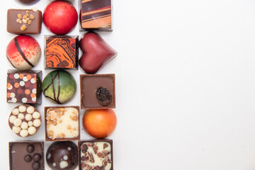 lot of variety chocolate pralines, top view of various chocolate pralines isolated on white background
