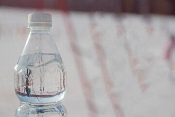 bottle of water on background, Ski park in Poland. New Year. People go skiing, go to the chair lift.