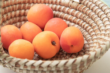 ripe apricots in plate on the table. Orange apricots fruits in bowl. Juicy apricots nutrition.