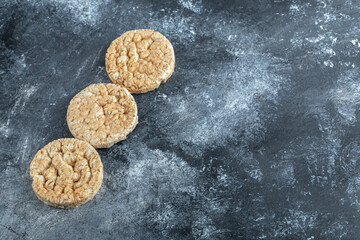 Three round crispbread on marble background