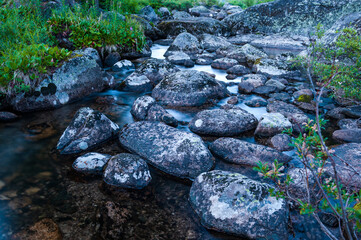 Taiga. Siberia. Ergaki. Mountain stream flowing from the lake 