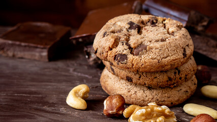 Organic food snack tasty sweet dessert milk dark chocolate chip salt cookie closeup piece fruit orange raspberry hazelnut nuts cinnamon on cocoa cacao powder wooden table for new year Christmas gift