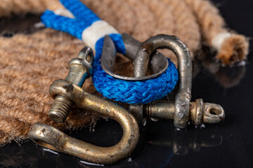 Wet shackle and rope. Accessories for sea wolves on the table.