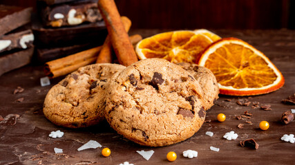 Organic food snack tasty sweet dessert milk dark chocolate chip salt cookie closeup piece fruit orange raspberry hazelnut nuts cinnamon on cocoa cacao powder wooden table for new year Christmas gift